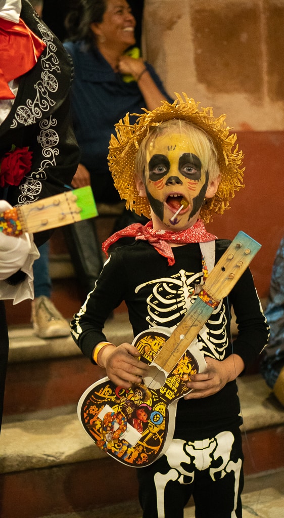 Boy dressed up for day of the dead with sucker in his mouth