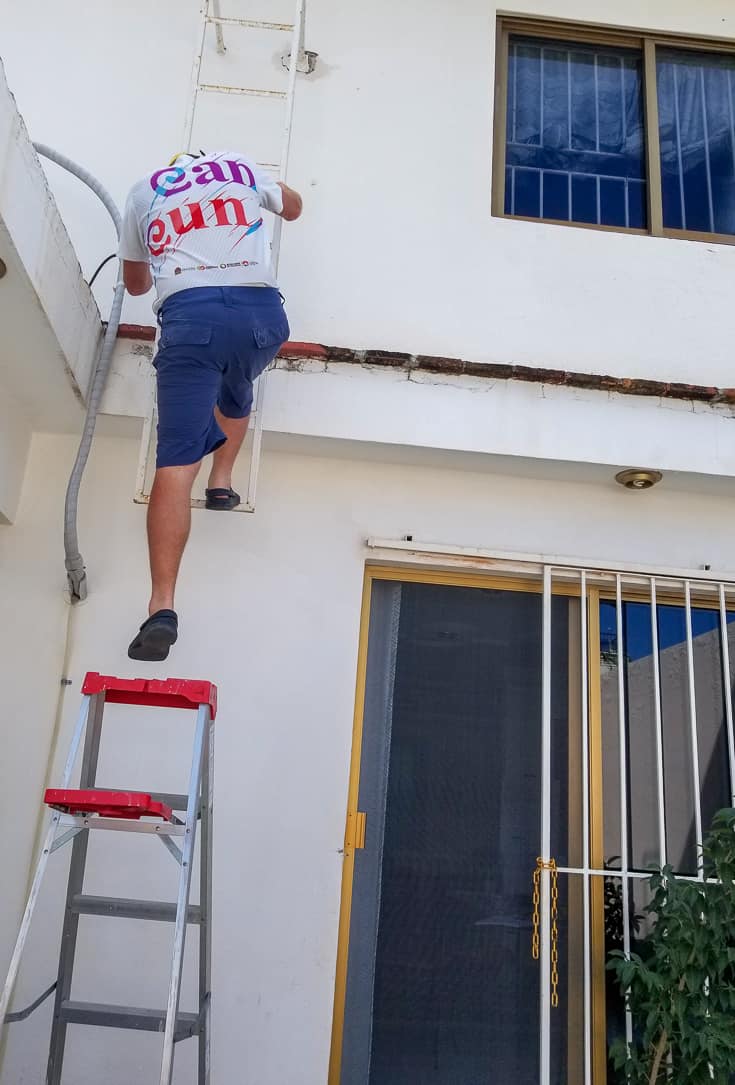 Matt climbing the ladder to get to the roof 