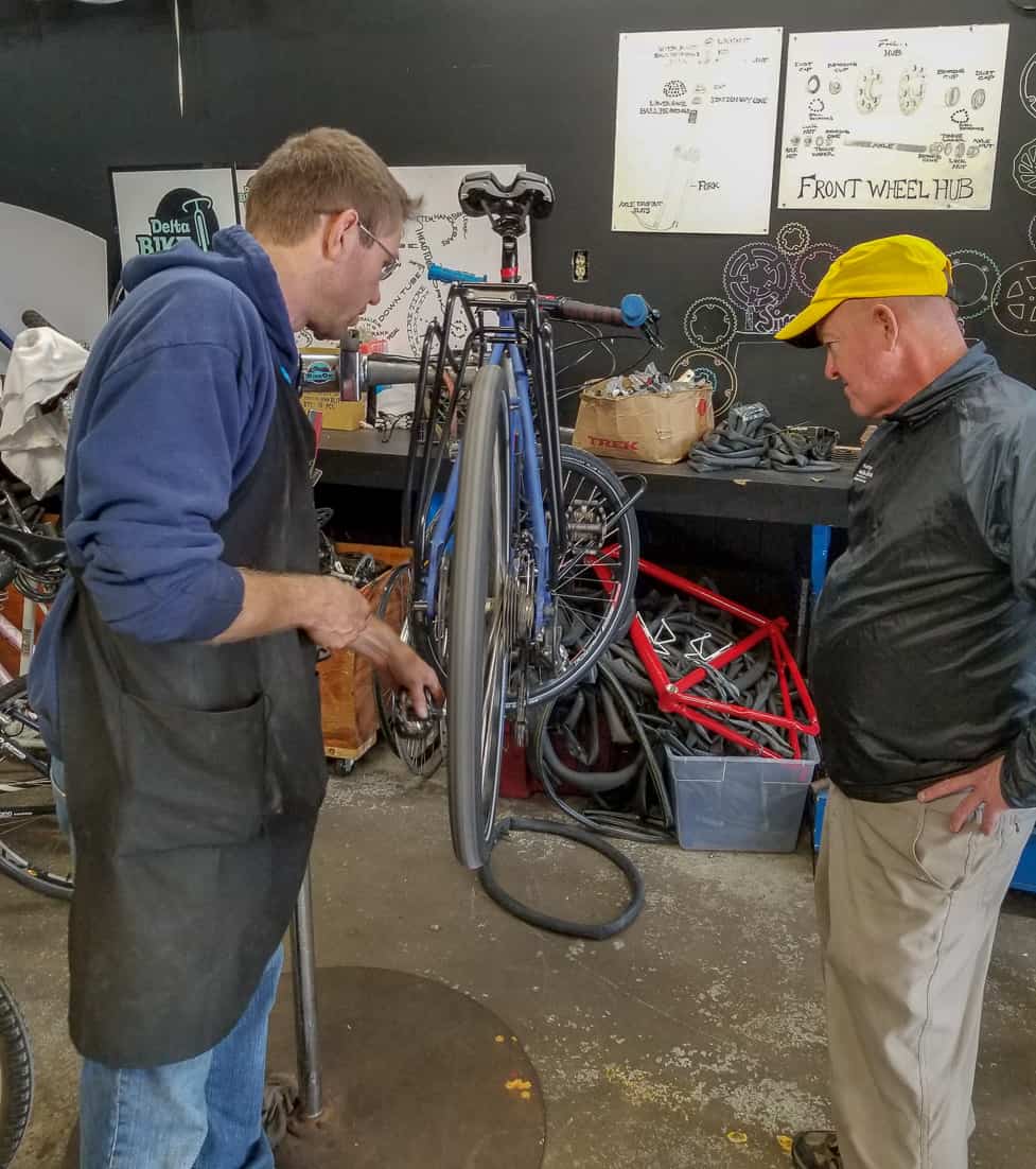 Volunteer at Delta Bike Project teaching Matt how to tune his bike