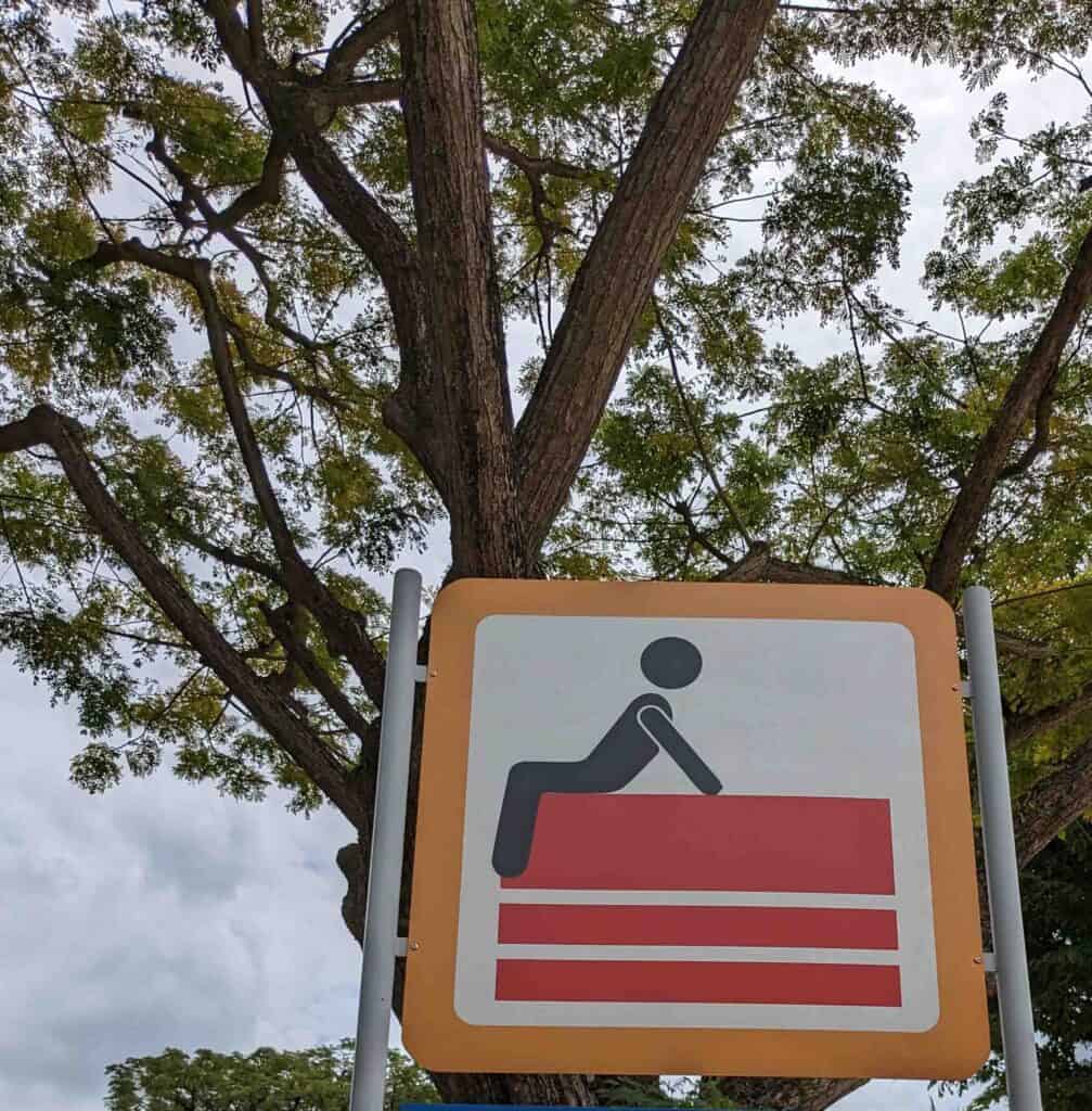 A sign with someone sitting
