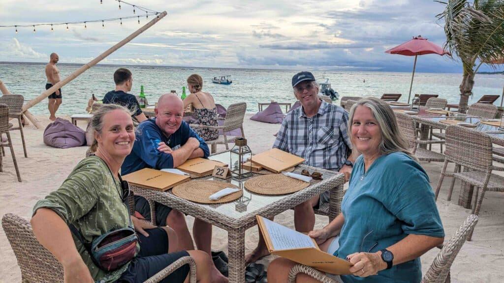 4 people eating at a beach restaurant