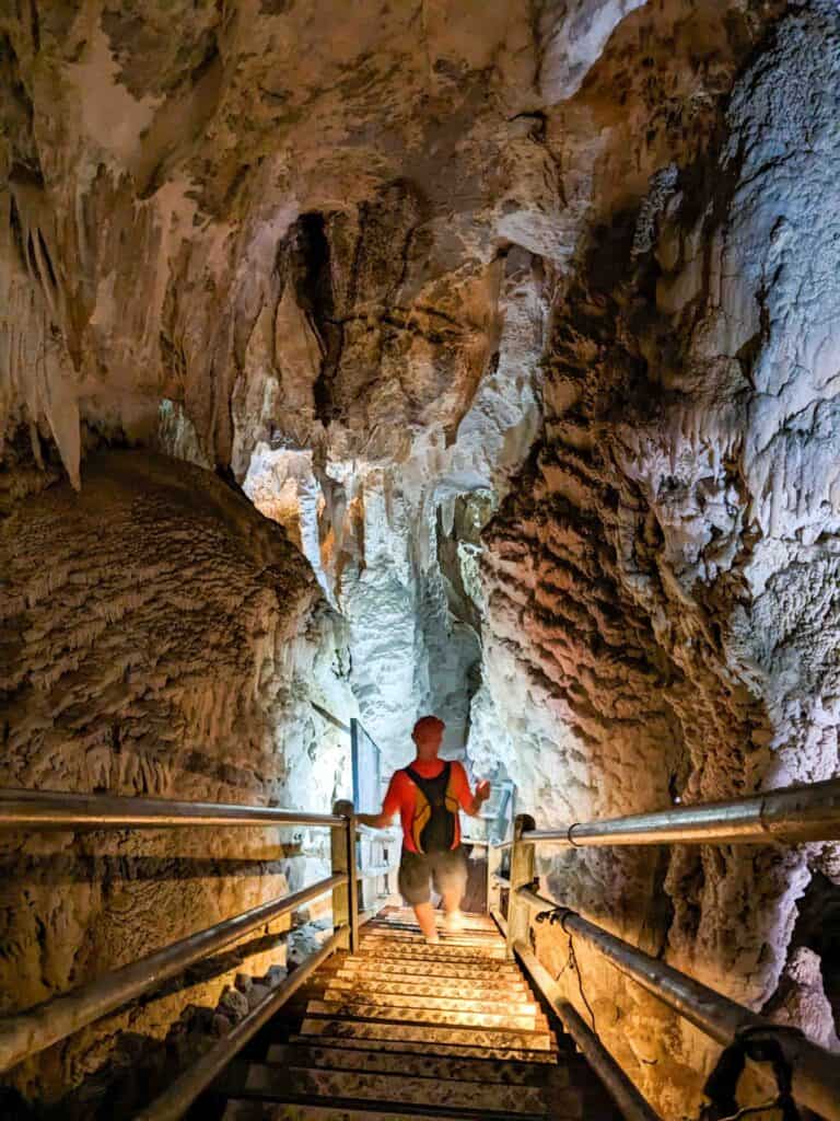 Man entering a cave by the stairs